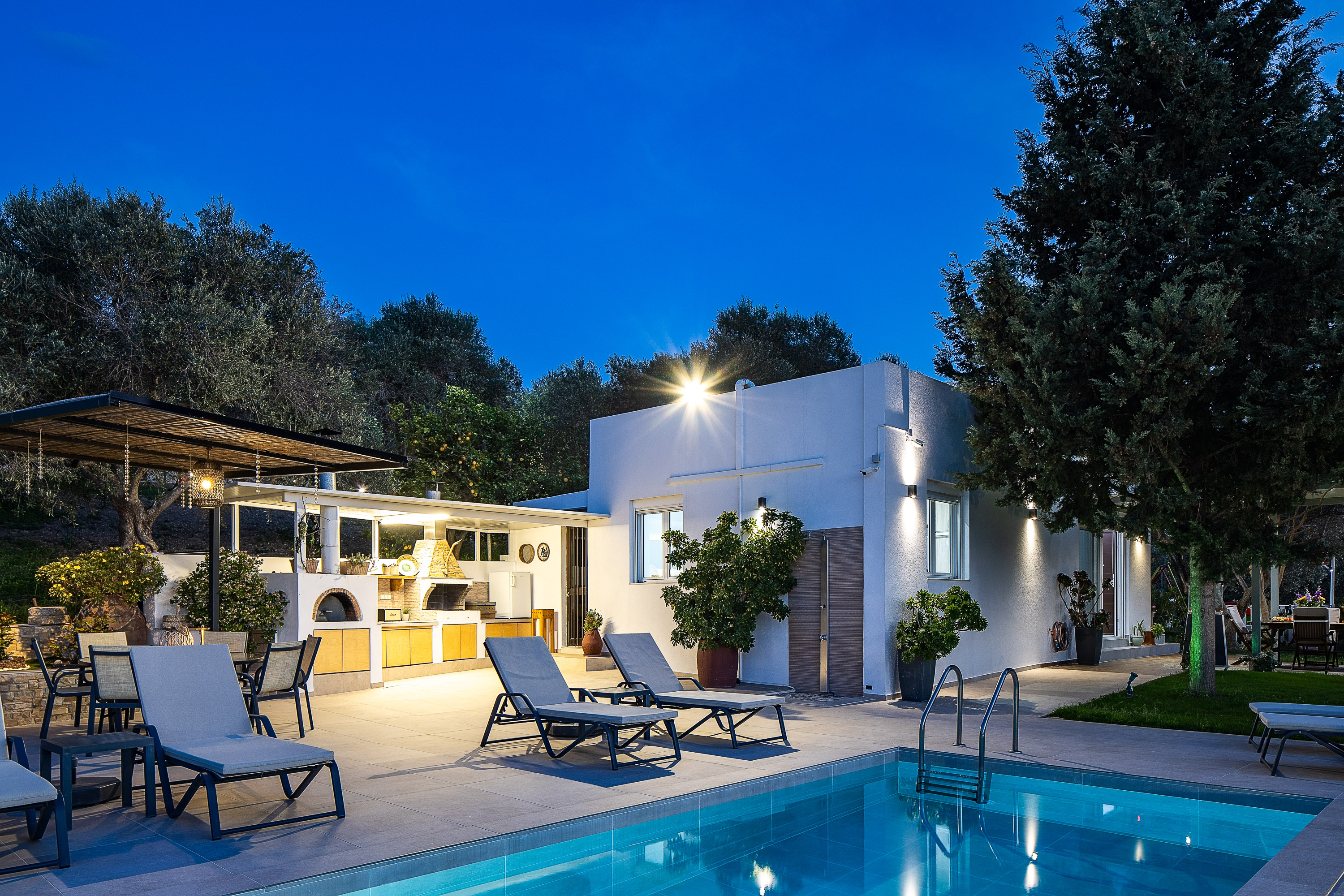 Experience the villa's enchanting ambiance as it transforms under the night sky.